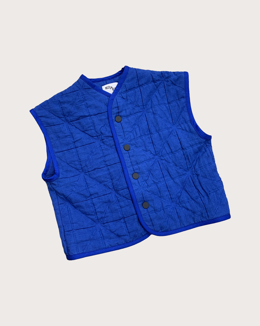 Nox kids padded quilted vest in cobalt blue organic cotton, flat lay front, Studio Koter